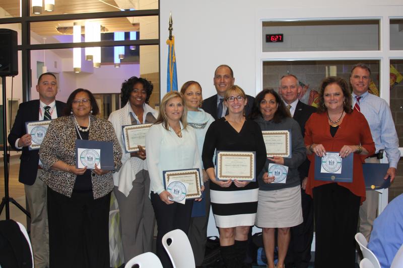 Principals and assistant principals received certificates from the Department of Safety and Homeland Security for providing excellent safety plans. Pictured (l-r) in back are Kevin Monoghan, Doris Person, Angela Thompson, Lisa Morris, Director of DEMA A.J. Schall, Secretary Robert Coupe and Superintendent Robert Fulton. In front are Kimberly Corbidge, Vivian Bush, Joanne Reihm and Patti Seabolt. MELISSA STEELE PHOTO